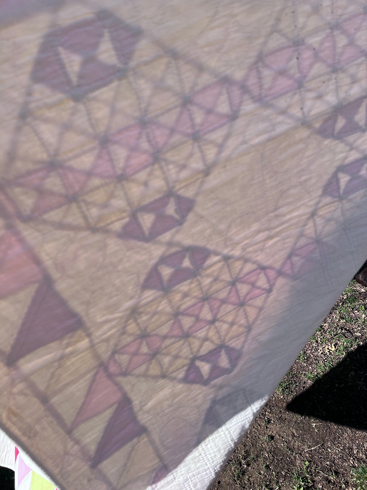 This lovely has white, red, pink and yellow, intricate triangles and hand quilting and stitching
