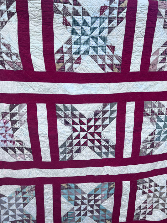 Complex  variation of the Feathered Star quilt with a bold red and the tiniest hand quilting stitches Antique quilt