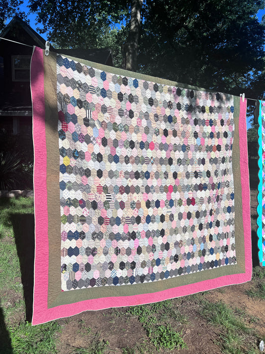 Hexagon pattern, often referred to in quilting as Grandmother’s Flower Garden when arranged in floral clusters, or simply a Hexie quilt.