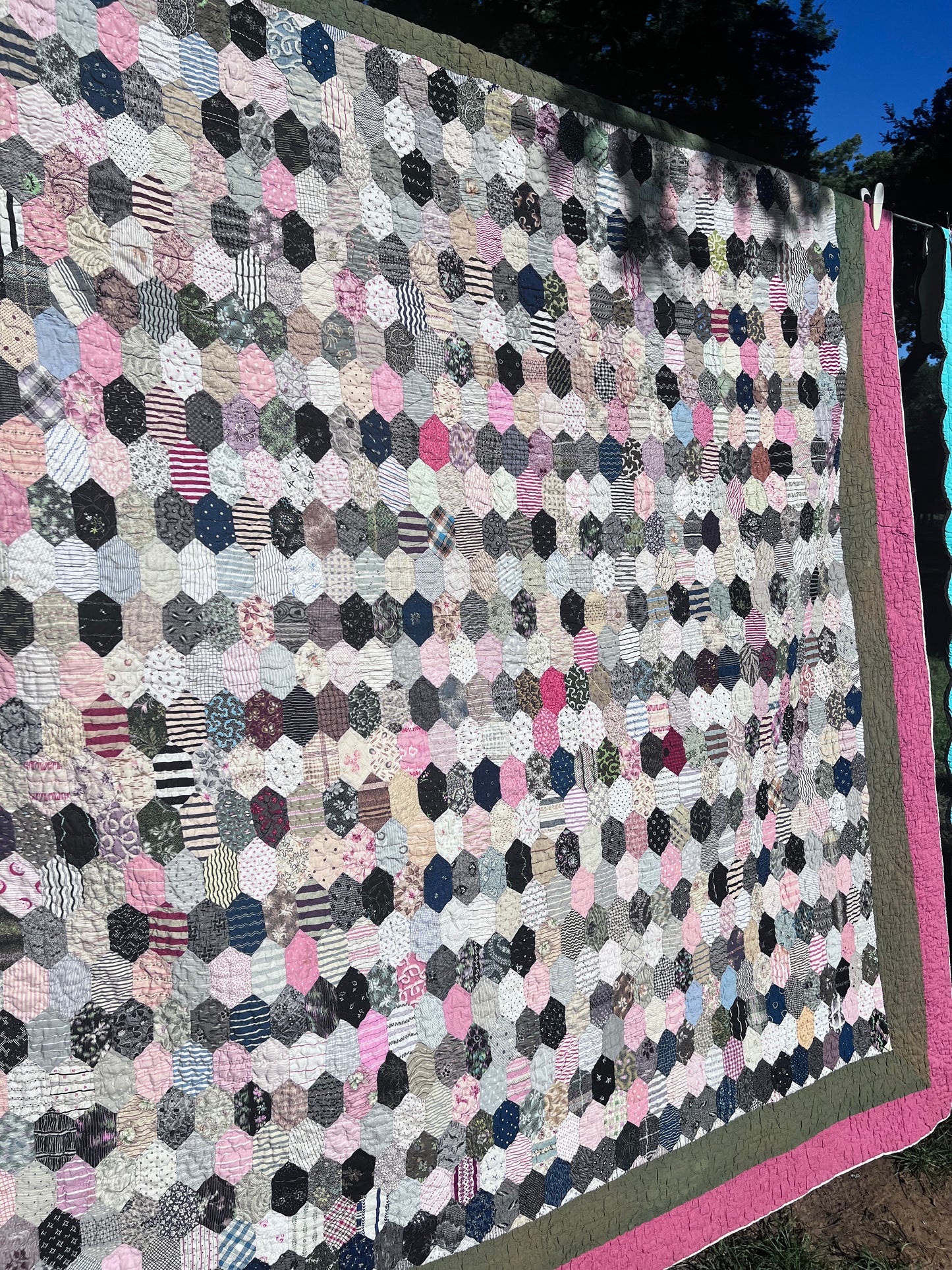Hexagon pattern, often referred to in quilting as Grandmother’s Flower Garden when arranged in floral clusters, or simply a Hexie quilt.