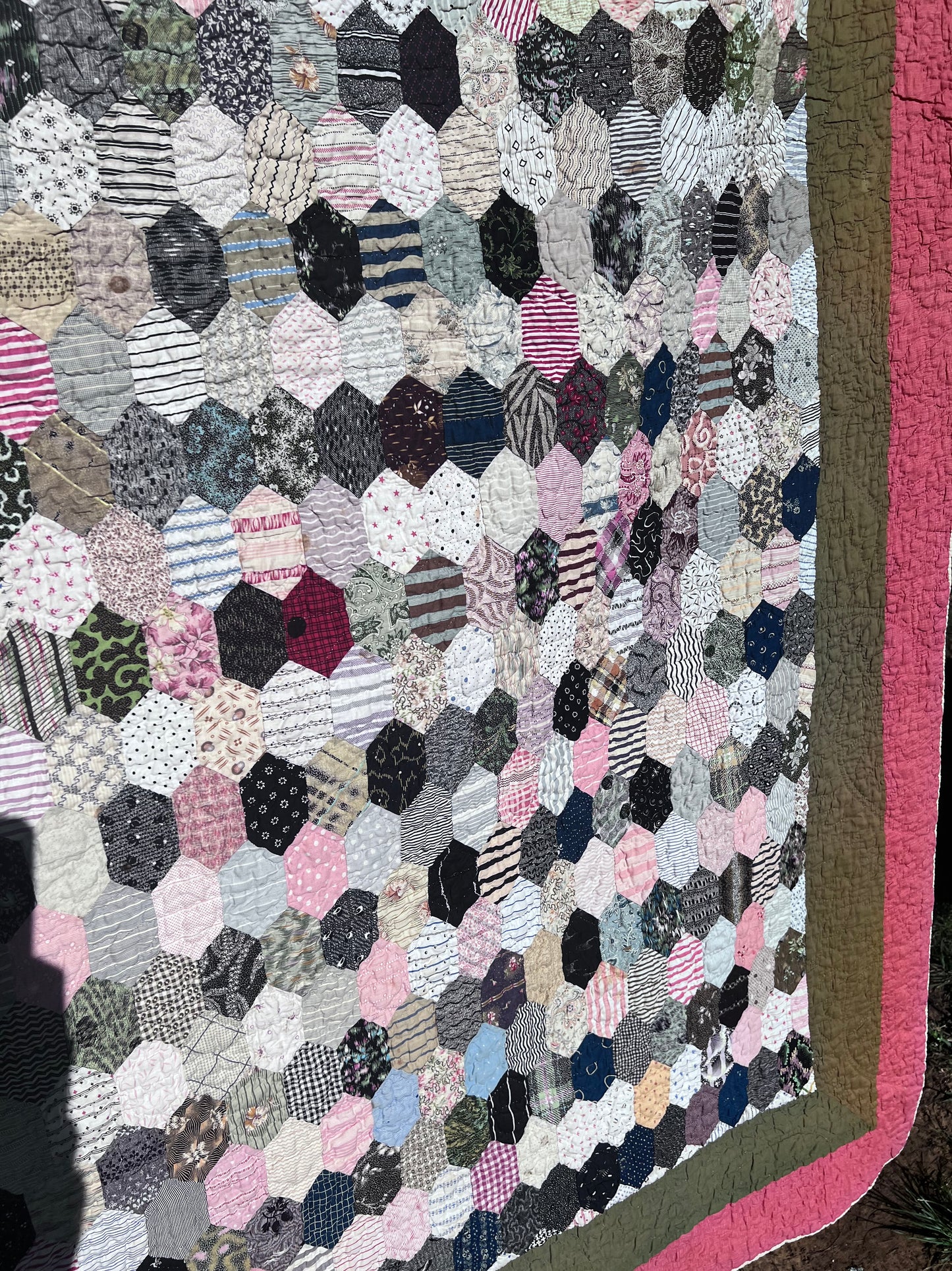 Hexagon pattern, often referred to in quilting as Grandmother’s Flower Garden when arranged in floral clusters, or simply a Hexie quilt.