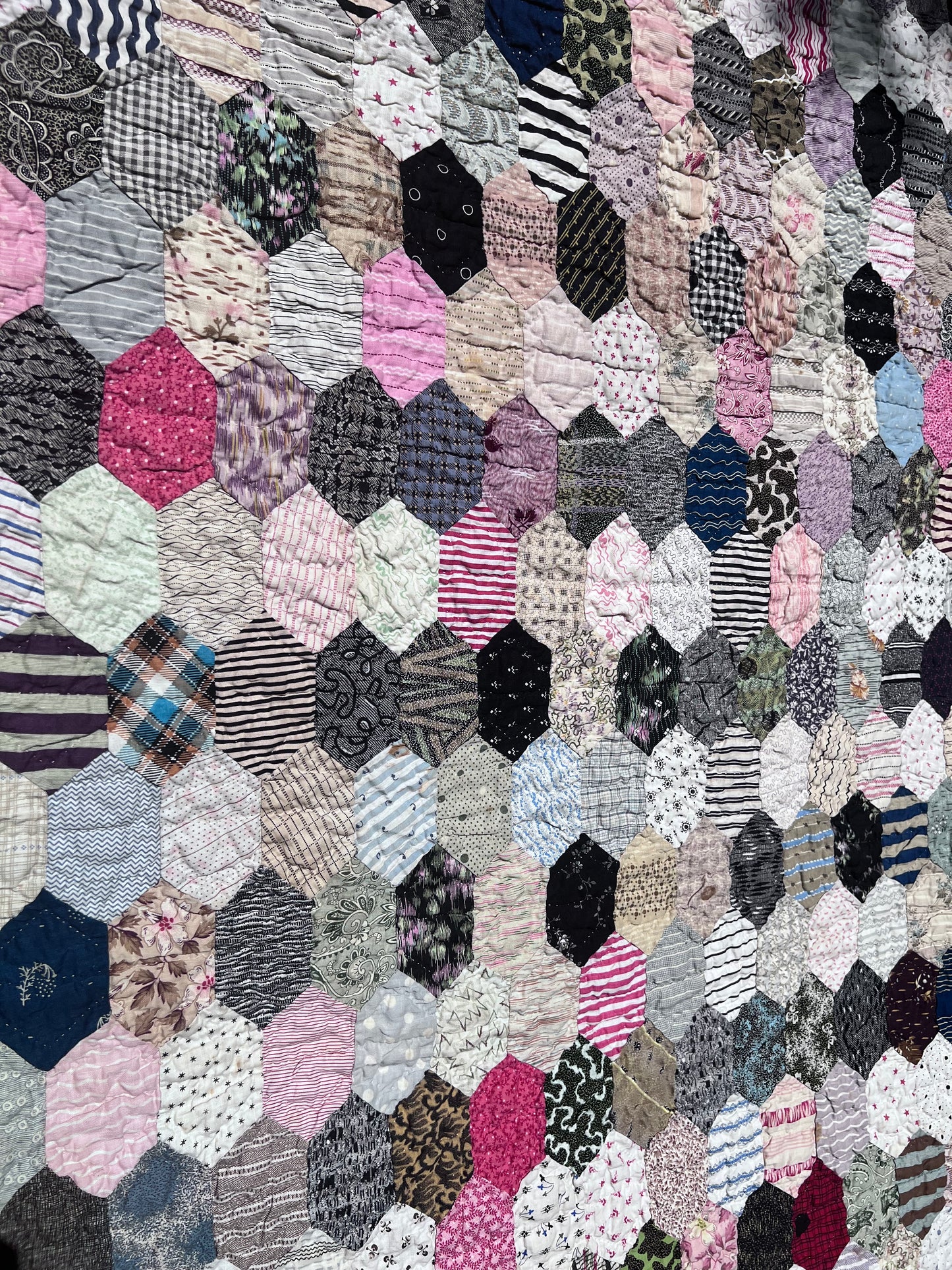 Hexagon pattern, often referred to in quilting as Grandmother’s Flower Garden when arranged in floral clusters, or simply a Hexie quilt.