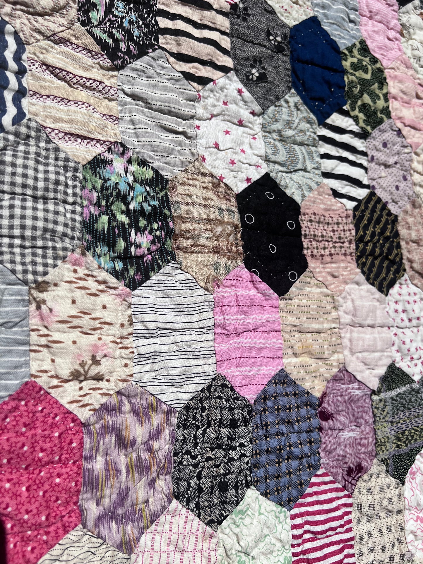 Hexagon pattern, often referred to in quilting as Grandmother’s Flower Garden when arranged in floral clusters, or simply a Hexie quilt.