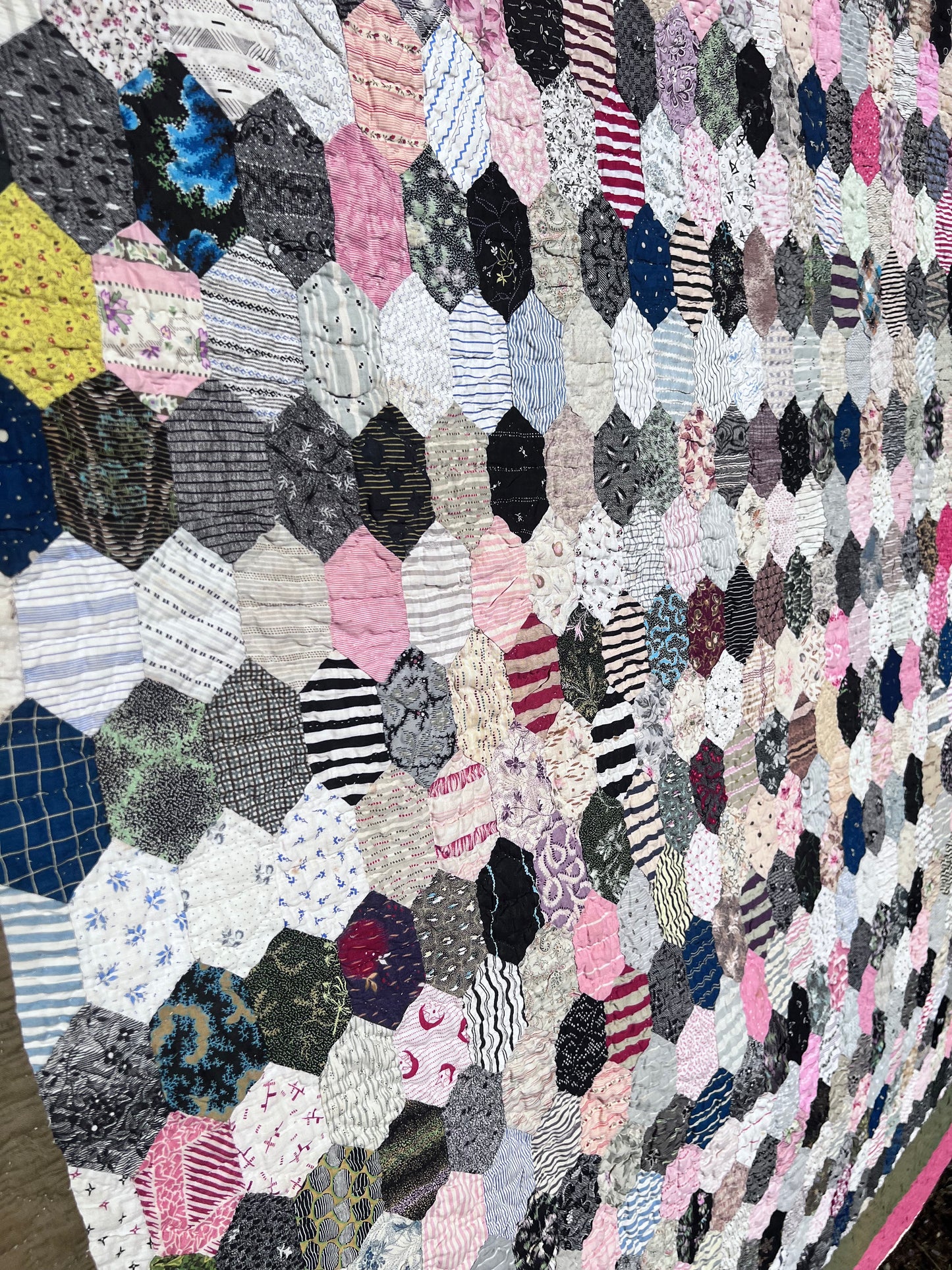 Hexagon pattern, often referred to in quilting as Grandmother’s Flower Garden when arranged in floral clusters, or simply a Hexie quilt.