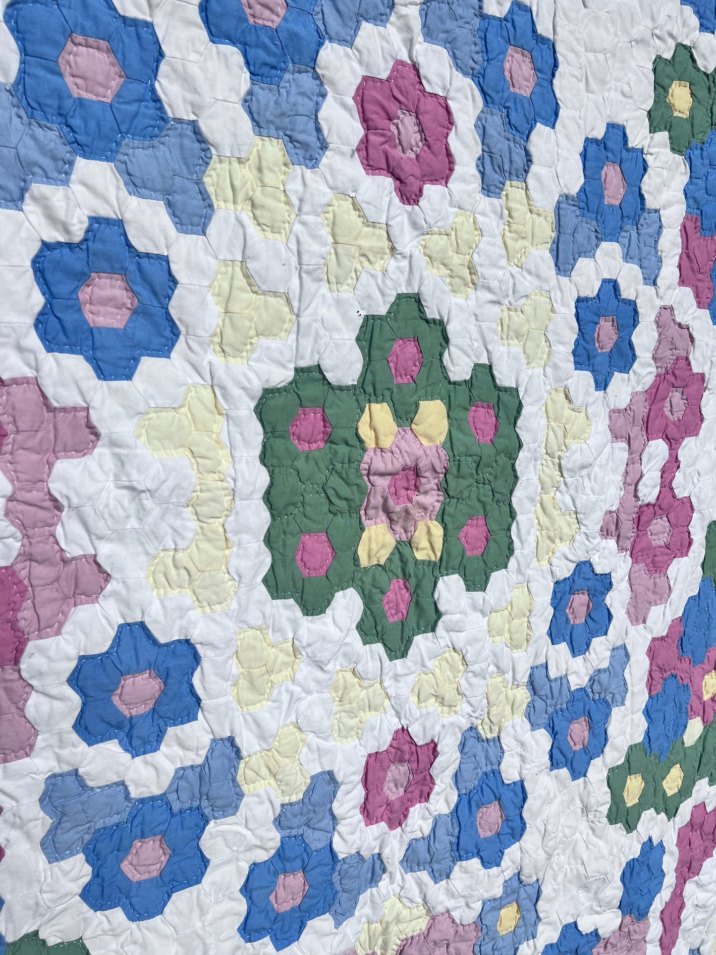 Tiny Hexi blocks creating a Grandmother's Flower Garden Style Vintage Quilt